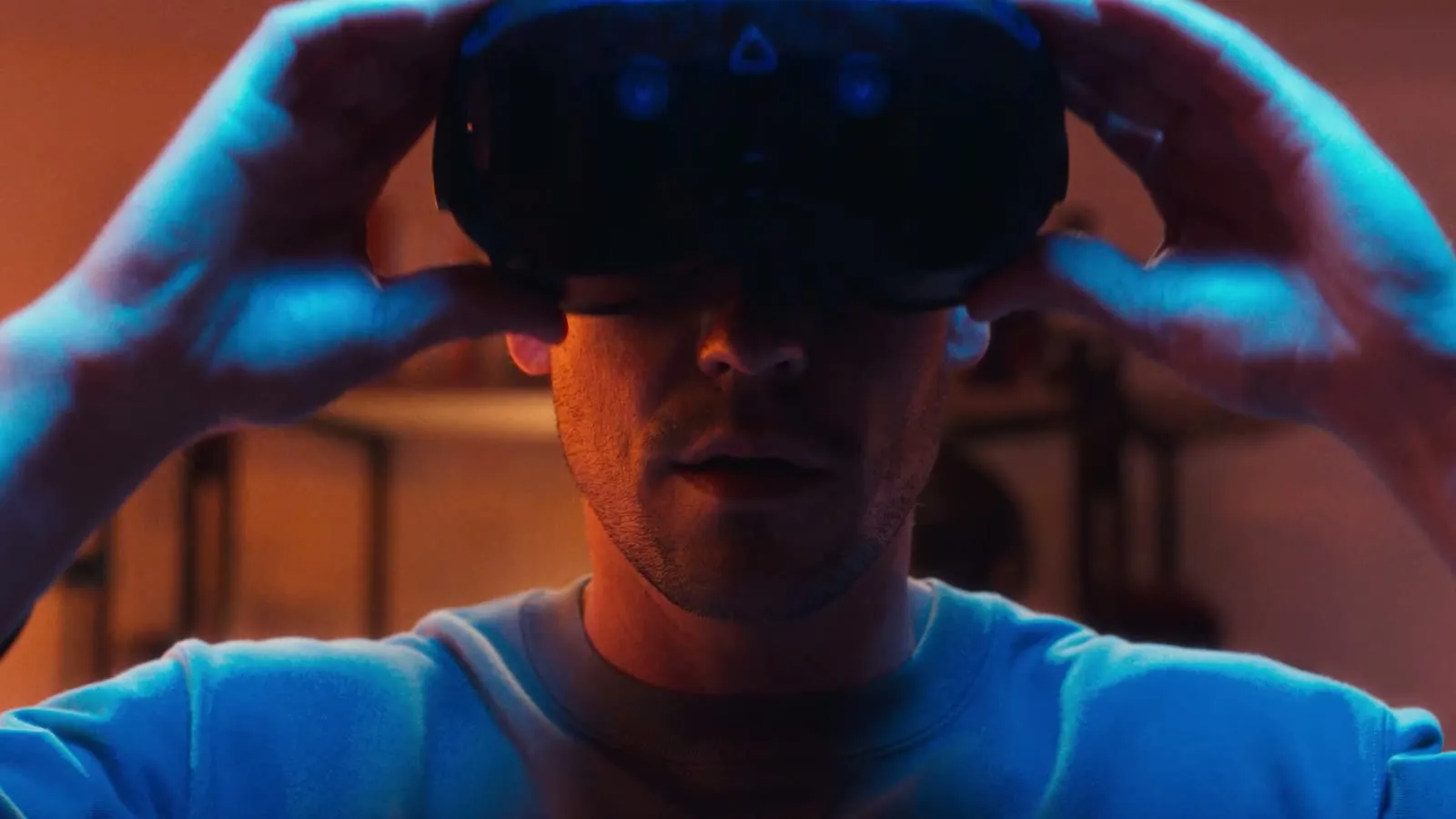 Frame from the reel — a headset lit blue and orange